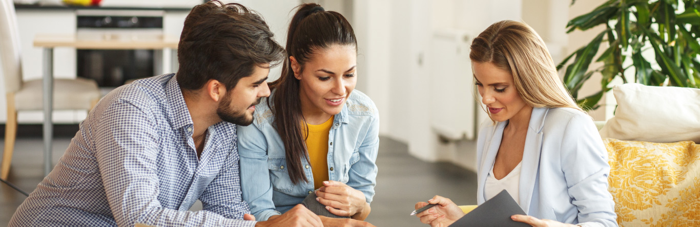 Young couple sitting with 1031 Exchange advisor